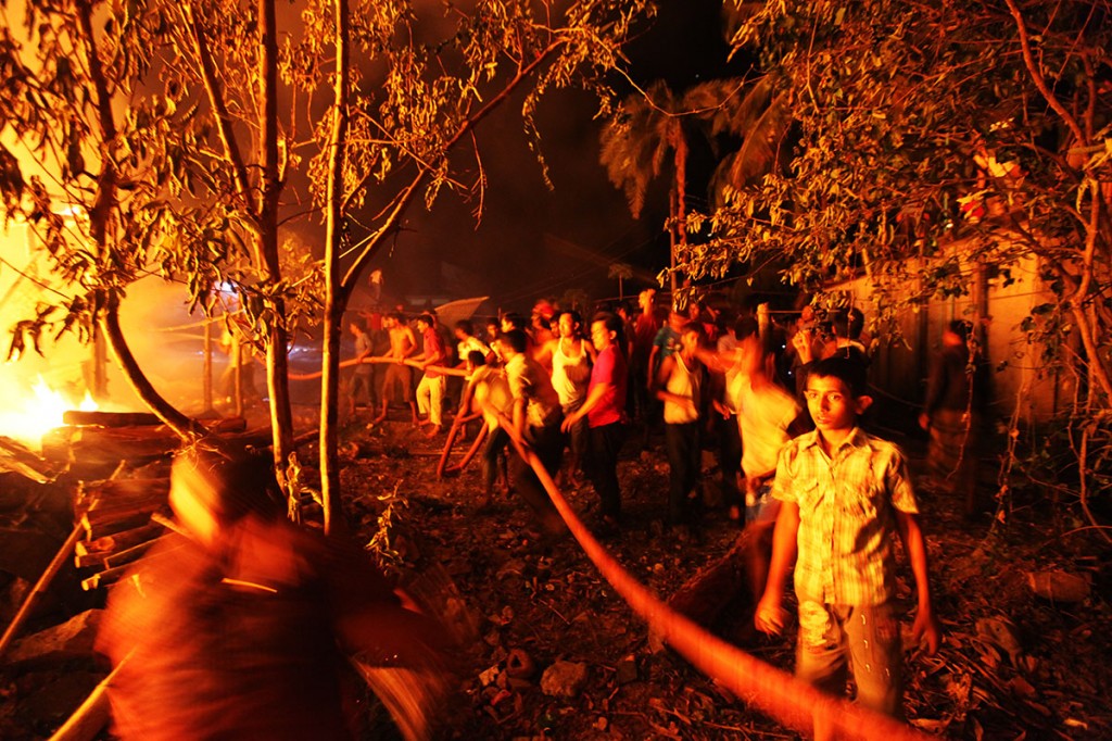 Neighbours looking for survivors. As it turned out most of the inhabitants were out and there was only an elderly couple whom neighbours were able to save. Photo: Shahidul Alam/Drik/Majority World