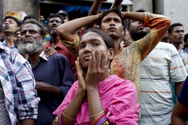 Shocked onlookers at wreckage of Rana Plaza, a building which collapsed on 24th April in Savar Bangladesh, killing many. Photo K M Asad