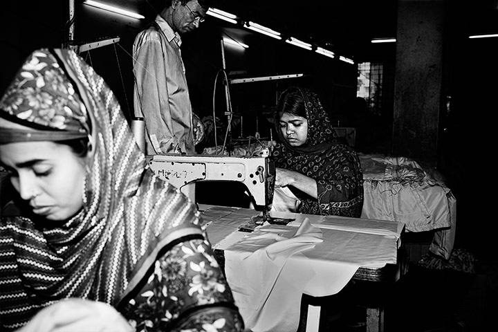  Shahana, aged 22 (left), and Hasina, aged 18 (right), at work in the sewing section of a garment factory in Rampura, Dhaka