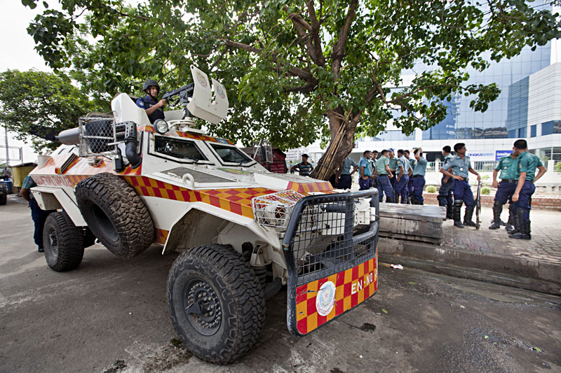 Armed police backed up by armoured vehicles with machine guns, protect illegally constructed BGMEA building. Photo: Shahidul Alam/Drik/Majority World