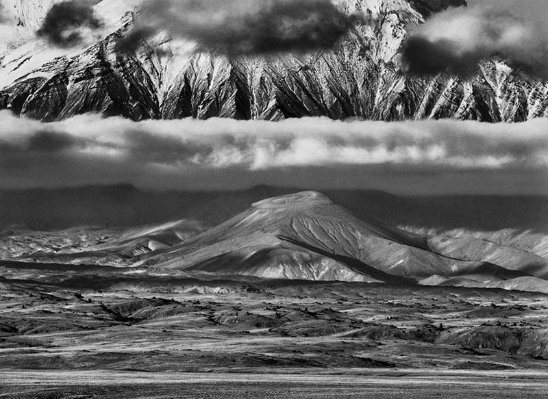 Russia, 2006 A tundra valley extends between Tolbachik and Kamen volcanoes in the Kamchatka Peninsula. A line of clouds separates a 2,600-foot crater from the huge base of Kamen volcano, which rises 15,000 feet above sea level.