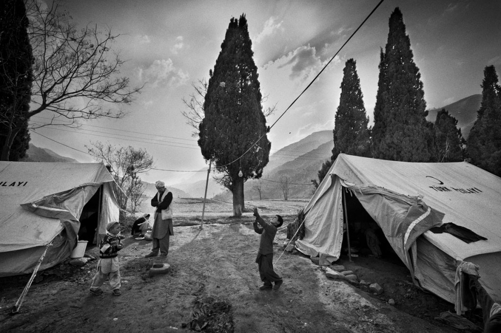 Boy playing with home made ball, in shelter built for earthquake victims in Pakistan. ? Shahidul Alam/Drik/Majority World