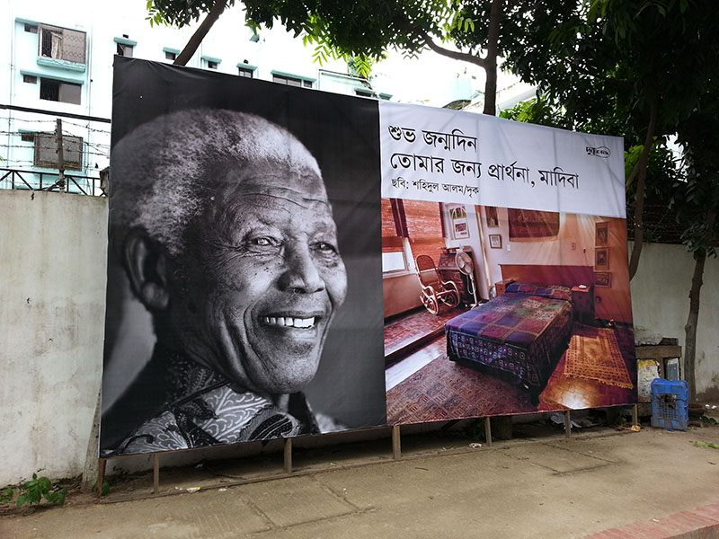 Banner outside Drik in Dhanmondi celebrating Nelson Mandela's (Madiba) 95th Birthday The bed next to him is in Fatima Meer?s house at 148 Burnwood Road, Durban, where Mandela, Tutu, Sisulu and Tambo would take shelter in. 15th July 2009. South Africa. ? Shahidul Alam/Drik/Majority World. 