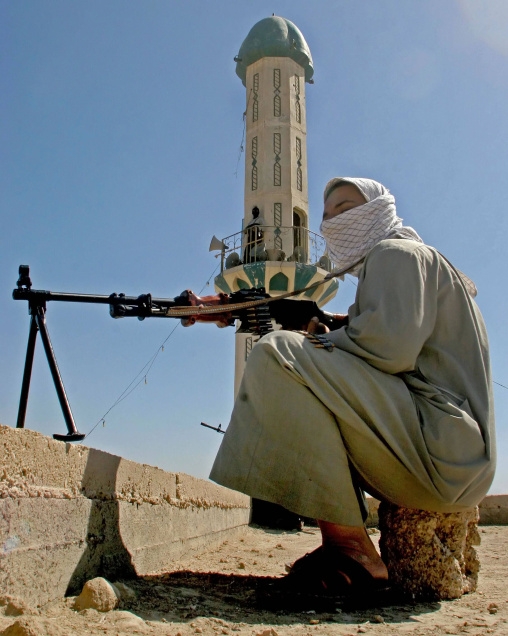 February 25, 2006: An Iraqi Mehdi Army militant guards a Sunni mosque in the southern city of Basra. Sectarian violence is the legacy of the American occupation of Iraq. Photo:ESSAM AL-SUDANI/AFP