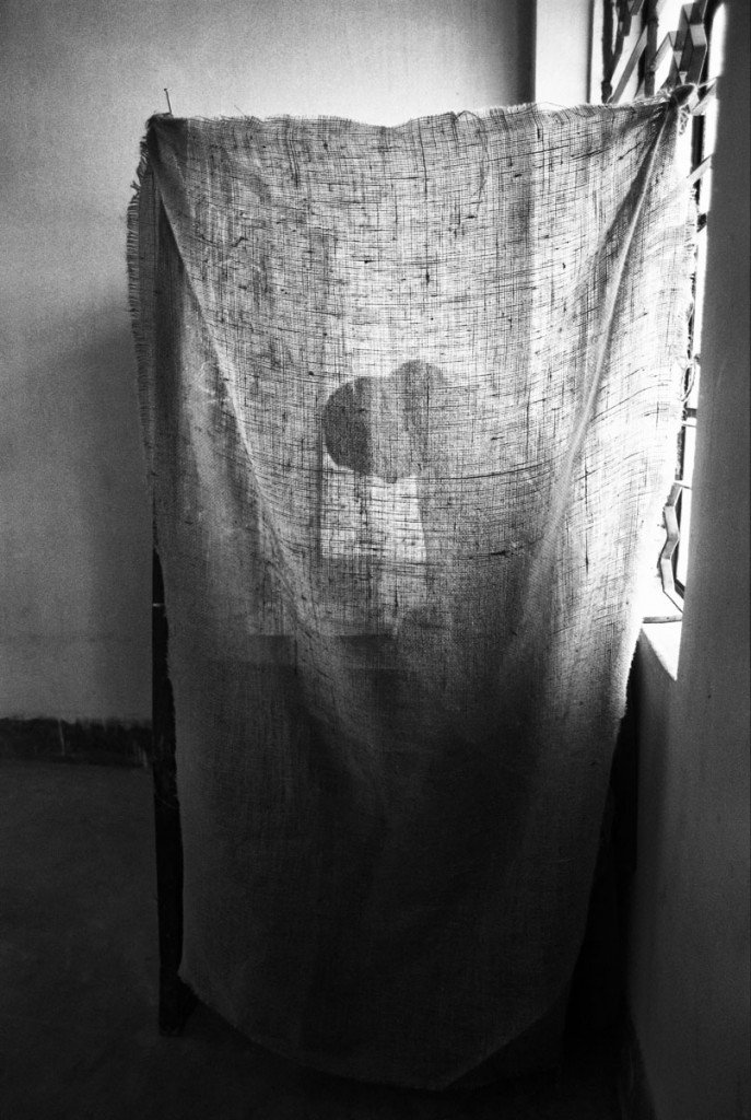 A woman in a makeshift voting booth in Lalmatia, Dhaka, casts her vote after the removal of autocratic General Hussain Mohammad Ershad after a sustained people's movement for democracy. Dhaka. Bangladesh. ? Shahidul Alam/Drik/Majority World