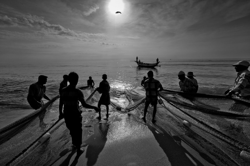 Fishermen in Sri Lanka who had lost their nets during the Tsunami return to their craft with the help of nets provided by aid agencies. ? Shahidul Alam/Drik/Majority World