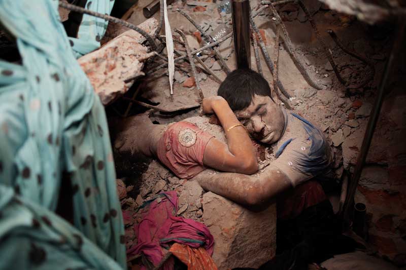 Workers killed in Rana Plaza embrace in death. Nobody knows who they were, whether they were related to each other or were strangers who had reached out to save each other, and had come close in the final moments of death. Savar, Dhaka. April 24, 2013. Photo ? Taslima Akhter