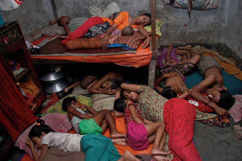 Eleven members of a garment worker?s family sleep at night, crammed into a small space. Mirpur, Dhaka. June 11, 2009. Photo ? Taslima Akhter