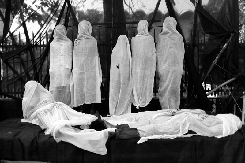 Young activists wearing shrouds demonstrate against the Tazreen factory fire on Victory Day, outside the National Museum, Shahbagh, Dhaka. December 16, 2012. Photo ? Abir Abdullah