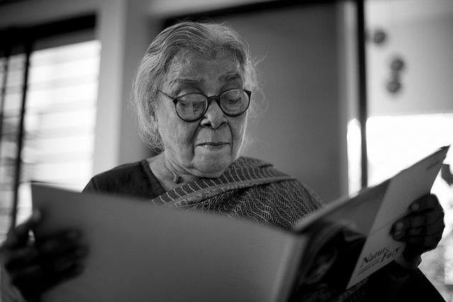 Mahasweta Devi looking at photo exhibition catalogue "Nature's Fury" by Shahidul Alam/Drik/Majority World