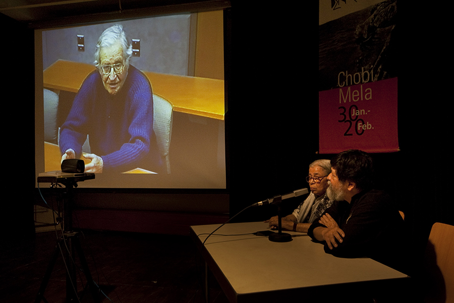 Noam Chomsky (on screen) and Mahasweta Devi, India's leading activist and writer in video conference moderated by Shahidul Alam during Chobi Mela. Photo: Drik